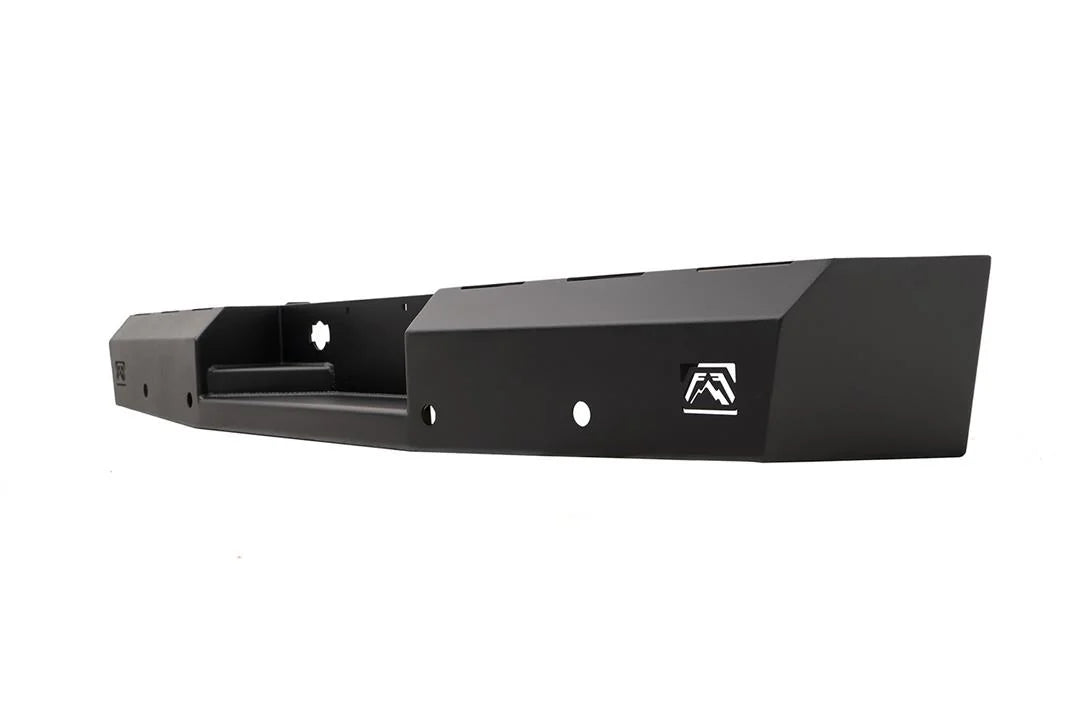 Fab Fours Red Steel rear bumper in black powder coat, angled view from the opposite end, showing the faceted end cap, logo cutout and recessed center section