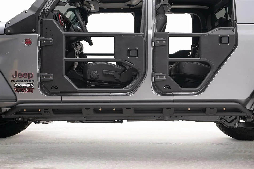 Close-up of the Fab Fours tube rock slider on a Jeep Gladiator, driver side, showing the double-tube rail