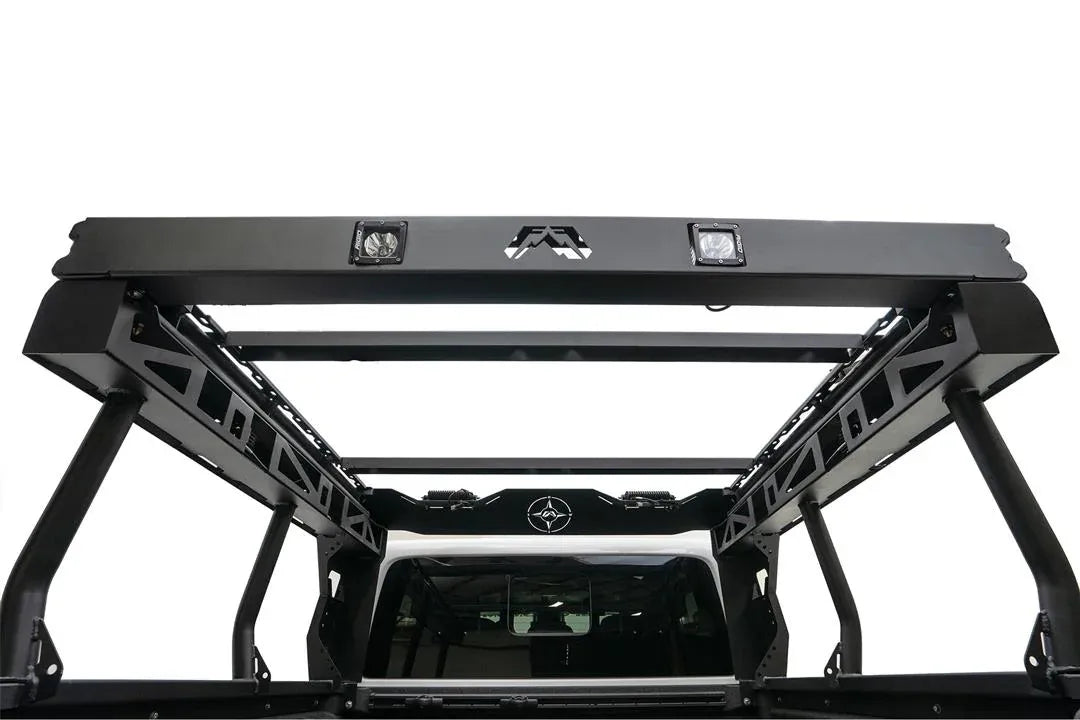 Fab Fours Overland Rack on a white Jeep Gladiator, rear view from the bed, showing two additional crossmembers spanning the platform between the side rails