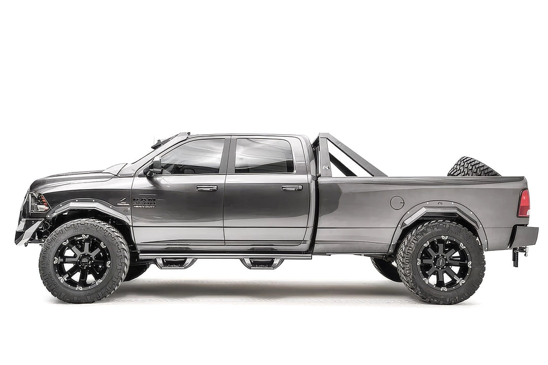 Fab Fours Open Fender System on a gray Ram 2500 crew cab, driver-side profile view, showing the open front and rear fenders, raised wheel openings and bolt-on fender trim