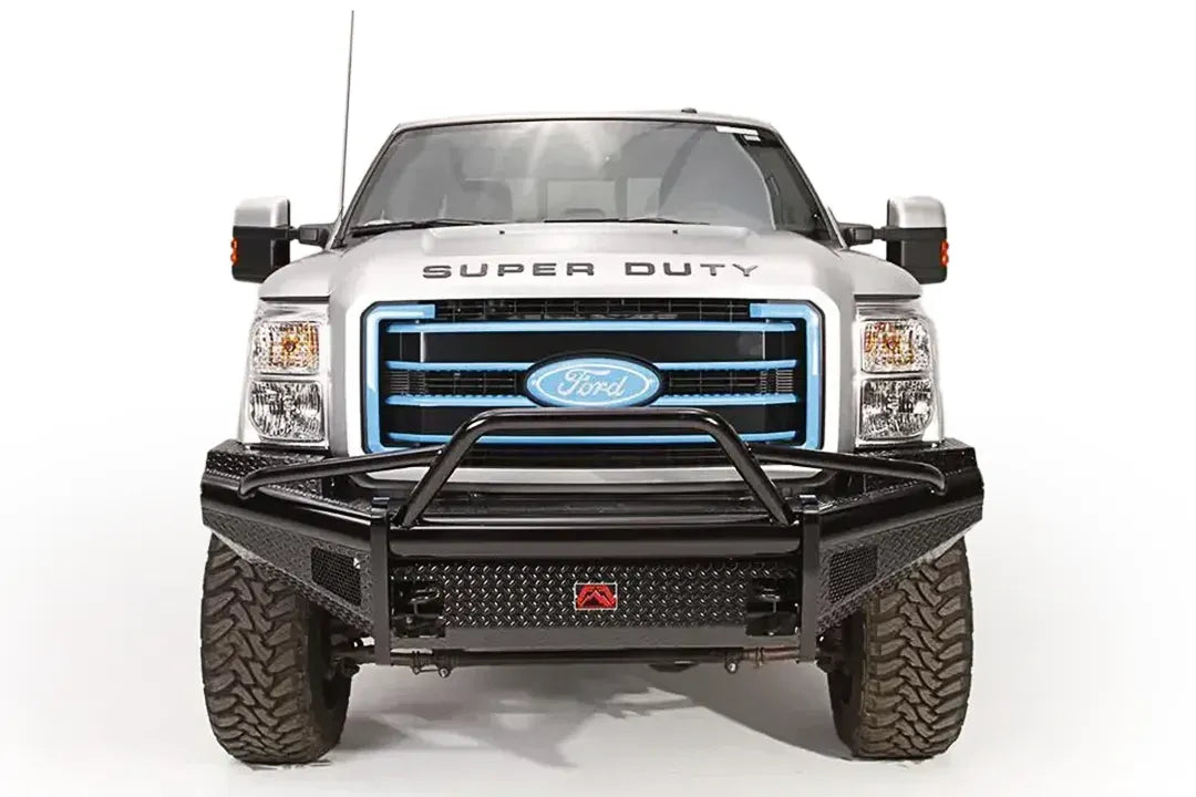 Fab Fours Black Steel front guard plate on a silver Ford Super Duty, front view, showing the diamond-plate guard plate, pre-runner guard tubing and black steel front bumper