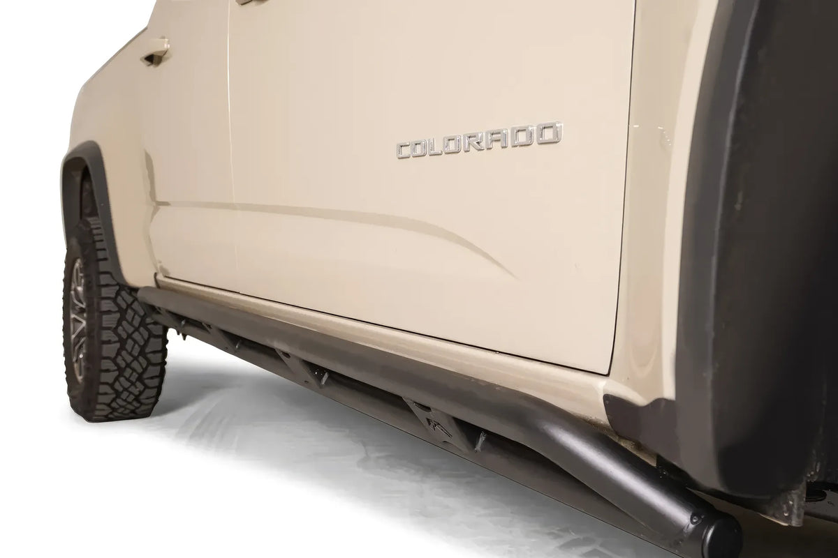 Close-up of Fab Fours rock slider tube on a tan Chevrolet Colorado ZR2