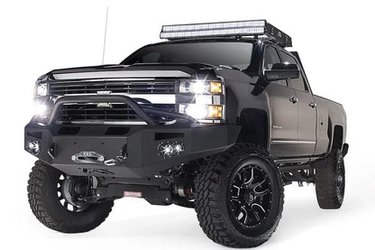 Fab Fours Premium heavy-duty winch front bumper with pre-runner guard on a lifted black Chevrolet Silverado 2500HD, driver-side front three-quarter view
