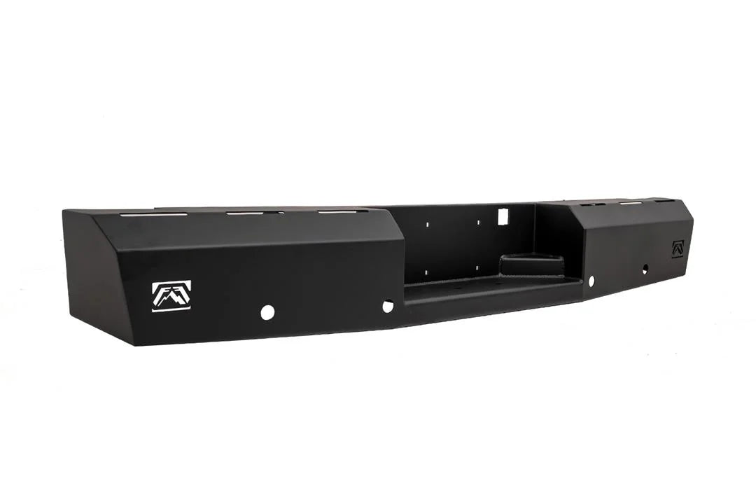 Fab Fours Red Steel rear bumper in black powder coat, angled view, showing the recessed center step, Fab Fours logo plates and light cutouts