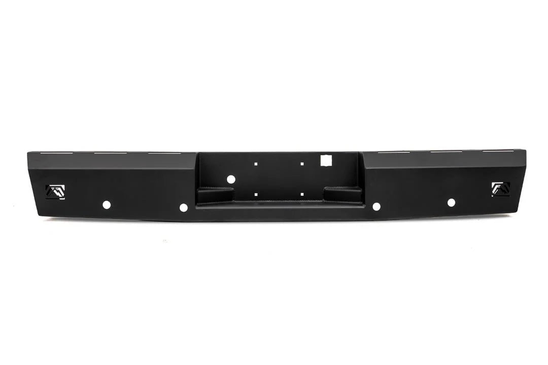 Fab Fours Red Steel rear bumper in black powder coat, straight-on view, showing the recessed center step, license plate mounting holes and Fab Fours logo plates