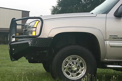 Fab Fours Black Steel front bumper with full guard on a silver Chevrolet Silverado 2500HD, front driver-side outdoor view, showing the full grille guard hoop, diamond-plate bumper top and wrap-around end