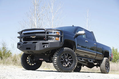 Fab Fours Premium heavy-duty winch front bumper with full grille guard on a lifted black Chevrolet Silverado 2500HD, driver-side front three-quarter view
