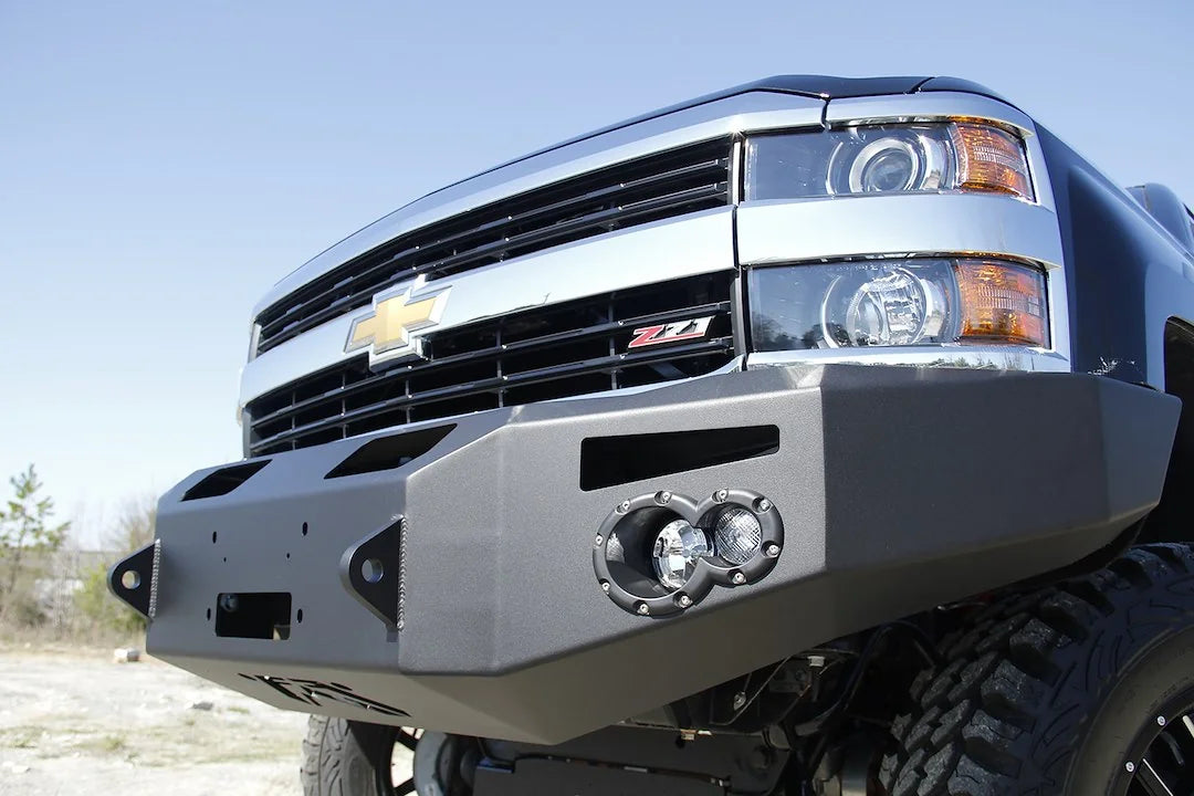 Close-up of Fab Fours Premium heavy-duty winch front bumper on a black Chevrolet Silverado 2500HD