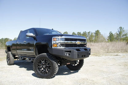 Fab Fours Premium heavy-duty winch front bumper on a lifted black Chevrolet Silverado 2500HD, alternate passenger-side front three-quarter view
