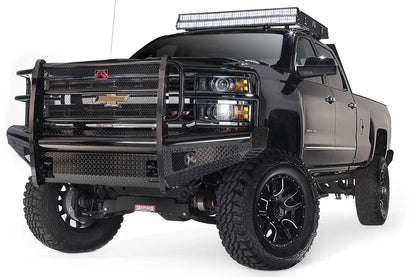 Fab Fours Black Steel front bumper with full guard on a black Chevrolet Silverado 2500HD, front passenger-side three-quarter view, showing the full grille guard with mesh insert, diamond-plate bumper face and Fab Fours logo