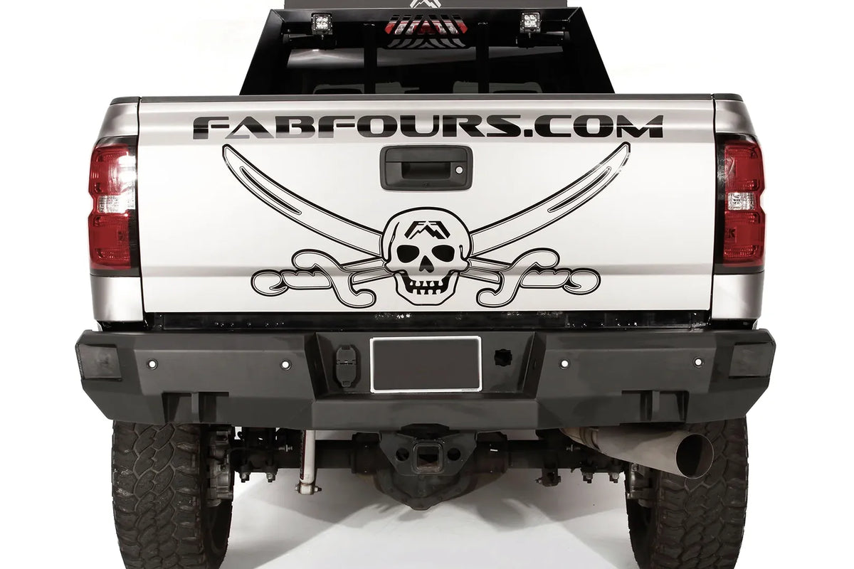 Fab Fours Premium rear bumper on a silver GMC Sierra 2500HD, straight-on rear view, showing the license plate recess, square light cutouts, shackle mounts and hitch receiver