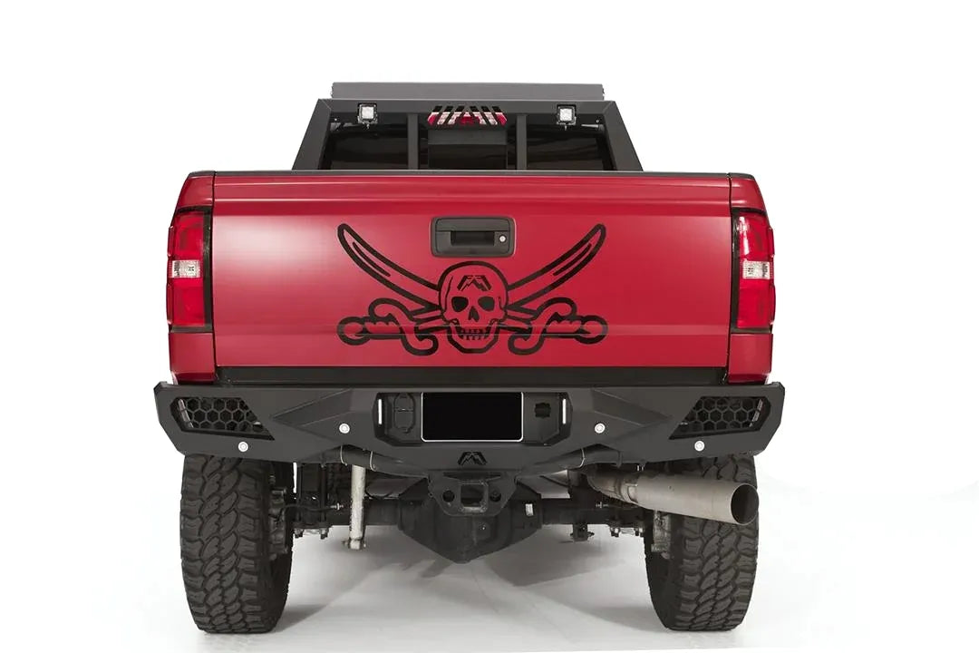 Fab Fours Vengeance rear bumper on a red GMC Sierra 2500HD, straight-on rear view, showing the honeycomb light pods, license plate recess and center hitch opening