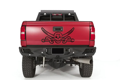 Fab Fours Vengeance rear bumper on a red GMC Sierra 2500HD, straight-on rear view, showing the honeycomb light pods, license plate recess and center hitch opening