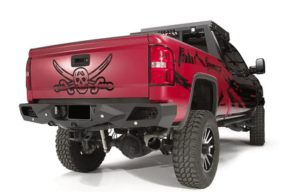 Fab Fours Vengeance rear bumper on a red GMC Sierra 2500HD, rear passenger-side three-quarter view, showing the honeycomb light pods, angular end caps and license plate recess