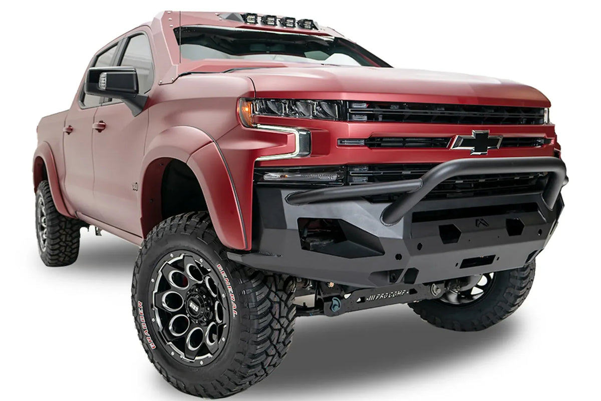 Fab Fours Matrix front bumper with pre-runner guard on a red Chevrolet Silverado, front passenger-side three-quarter view, showing the pre-runner guard tubing, hex light cutouts and Fab Fours logo