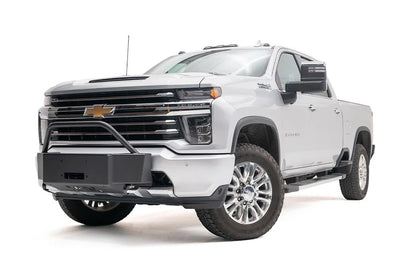 Fab Fours winch mount with pre-runner guard on a white Chevrolet Silverado 2500HD, front driver-side three-quarter view, showing the pre-runner hoop, winch mount plate and fairlead opening