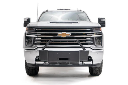 Fab Fours winch mount with pre-runner guard on a white Chevrolet Silverado 2500HD, straight-on front view, showing the pre-runner hoop, winch mount plate and fairlead opening