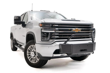 Fab Fours winch mount with pre-runner guard on a white Chevrolet Silverado 2500HD, front passenger-side three-quarter view, showing the pre-runner hoop, winch mount plate and fairlead opening