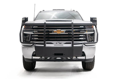 Fab Fours winch mount with full guard on a white Chevrolet Silverado 2500HD, straight-on front view, showing the full grille guard uprights, winch mount plate and Fab Fours logo