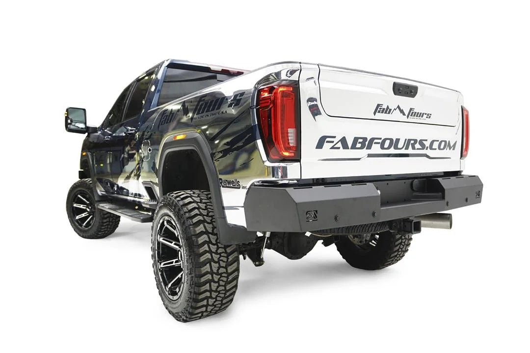 Fab Fours Red Steel rear bumper on a chrome-wrapped GMC Sierra HD, rear driver-side three-quarter view, showing the flat bumper face, integrated light cutouts and wrap-around ends