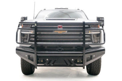 Fab Fours Black Steel front bumper with full guard on a white Chevrolet Silverado 2500HD, straight-on front view, showing the full-width grille guard, center receiver opening and diamond-plate bumper face