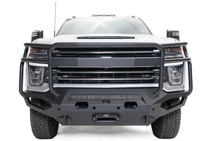 Fab Fours Matrix front bumper with full guard on a white Chevrolet Silverado 2500HD, straight-on front view, showing the full-width tubular guard, center light bar and winch fairlead opening
