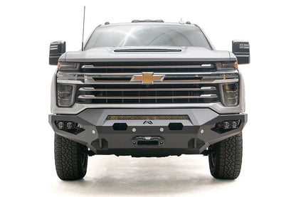 Fab Fours Matrix front bumper on a silver Chevrolet Silverado 2500HD, straight-on front view, showing the center light bar, winch fairlead opening and pod light cutouts
