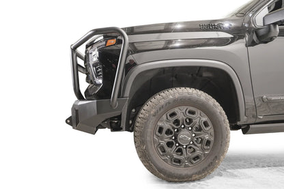 Fab Fours Premium Winch front bumper with full guard on a dark gray Chevrolet Silverado 2500HD, side close-up of the front corner, showing the guard upright, bumper end wing and shackle mount