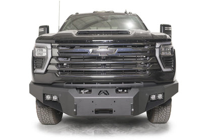 Fab Fours Premium Winch front bumper on a dark gray Chevrolet Silverado 2500HD, straight-on front view, showing the no-guard design, center winch fairlead opening and pod light cutouts