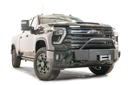 Fab Fours Winch Mount with pre-runner guard on a black Chevrolet Silverado 2500HD, front driver-side three-quarter view, showing the pre-runner hoop, winch mount face and roller fairlead