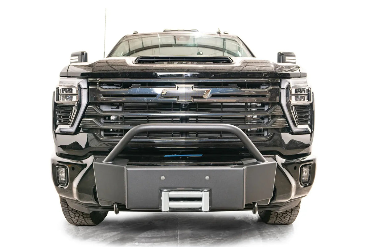 Fab Fours Winch Mount with pre-runner guard on a black Chevrolet Silverado 2500HD, straight-on front view, showing the pre-runner hoop, winch mount face and roller fairlead