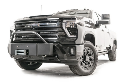 Fab Fours Winch Mount with pre-runner guard on a black Chevrolet Silverado 2500HD, front passenger-side three-quarter view, showing the tubular pre-runner hoop, boxed winch plate and roller fairlead