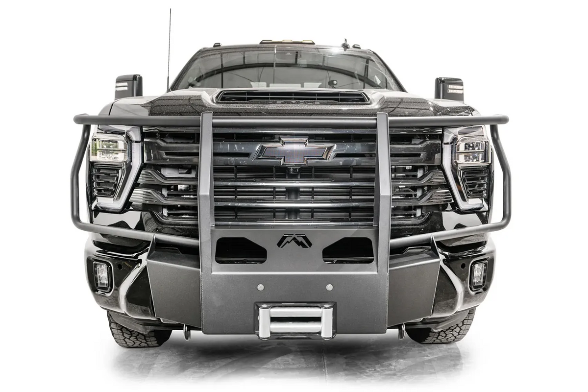 Fab Fours Winch Mount with full guard on a black Chevrolet Silverado 2500HD, straight-on front view, showing the full-width tubular guard, logo cutout and roller fairlead