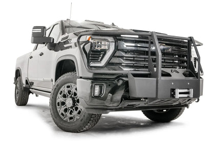 Fab Fours Winch Mount with full guard on a black Chevrolet Silverado 2500HD, front passenger-side three-quarter view, showing the tubular guard uprights, winch plate and roller fairlead