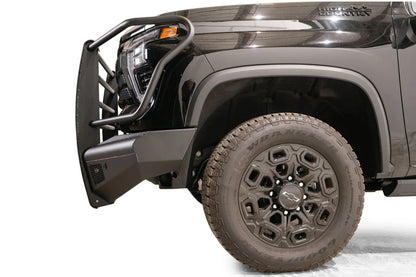Fab Fours Black Steel Elite front bumper with full guard on a black Chevrolet Silverado 2500HD, side close-up of the front corner, showing the guard hoop profile, bumper end wing and wheel clearance