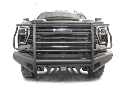 Fab Fours Black Steel Elite front bumper with full guard on a black Chevrolet Silverado 2500HD, straight-on front view, showing the full-width tubular guard, slotted center skid plate and pod light openings