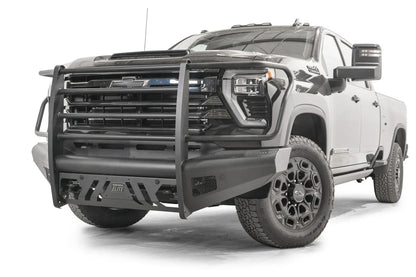 Fab Fours Black Steel Elite front bumper with full guard on a black Chevrolet Silverado 2500HD, front driver-side three-quarter view, showing the tubular full grille guard, slotted skid plate and mesh side vents