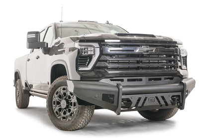 Fab Fours Black Steel Elite front bumper on a black Chevrolet Silverado 2500HD, front passenger-side three-quarter view, showing the no-guard design, mesh side vent and slotted skid plate