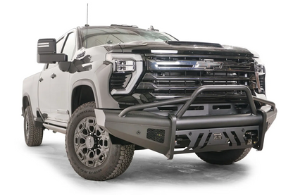 Fab Fours Black Steel Elite front bumper with pre-runner guard on a black Chevrolet Silverado 2500HD, front passenger-side three-quarter view, showing the pre-runner hoop, mesh side vent and slotted skid plate