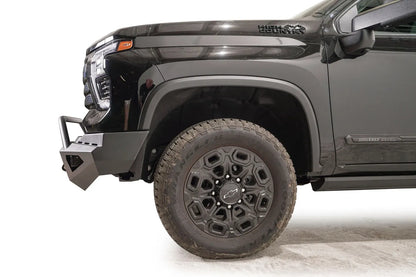 Fab Fours Red Steel front bumper with pre-runner guard on a black Chevrolet Silverado 2500HD, side close-up of the front corner, showing the pre-runner tube, shackle mount and bumper end wing