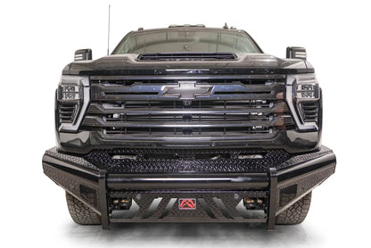 Fab Fours Black Steel front bumper on a black Chevrolet Silverado 2500HD, straight-on front view, showing the diamond-plate bumper face, slotted skid plate and red logo plate