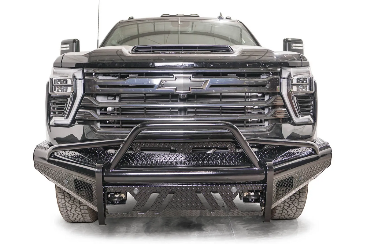 Fab Fours Black Steel front bumper with pre-runner guard on a black Chevrolet Silverado 2500HD, straight-on front view, showing the pre-runner hoop, diamond-plate top panel and slotted skid plate