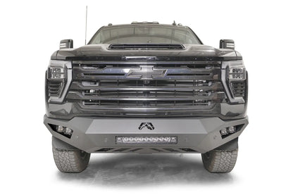Fab Fours Vengeance front bumper on a dark gray Chevrolet Silverado 2500HD, straight-on front view, showing the no-guard design, integrated center light bar and pod light openings
