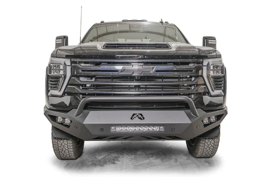Fab Fours Vengeance front bumper with pre-runner guard on a dark gray Chevrolet Silverado 2500HD, straight-on front view, showing the pre-runner hoop, center light bar and pod light openings