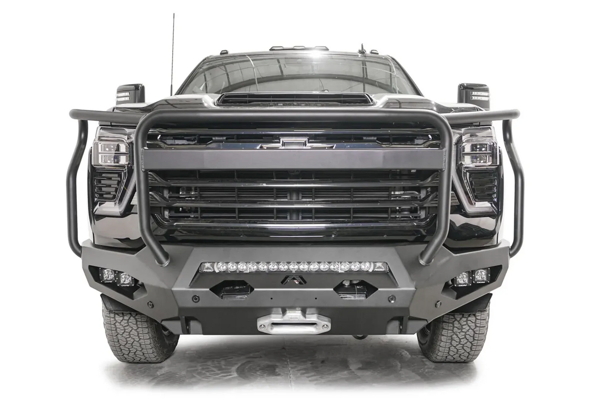 Fab Fours Matrix front bumper with full guard on a black Chevrolet Silverado 2500HD, straight-on front view, showing the tubular full grille guard, integrated light bar and winch fairlead