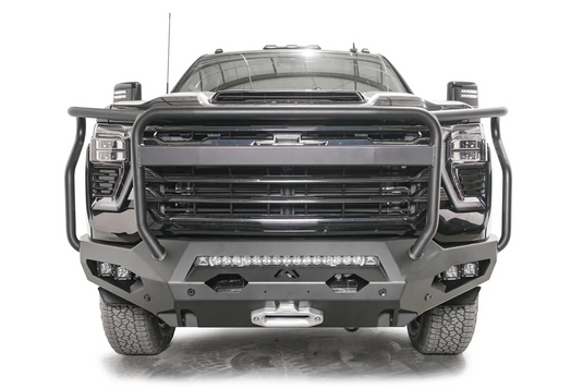 Fab Fours Matrix front bumper with full guard on a black Chevrolet Silverado 2500HD, straight-on front view, showing the tubular full grille guard, integrated light bar and winch fairlead
