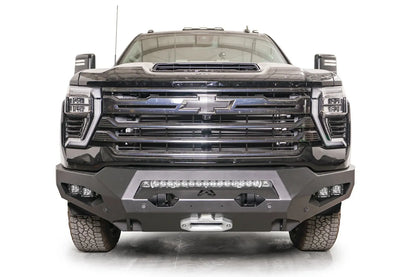Fab Fours Matrix front bumper on a black Chevrolet Silverado 2500HD, straight-on front view, showing the center light bar, winch fairlead and pod light openings