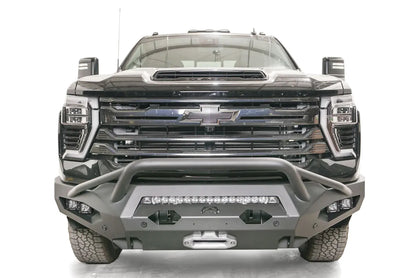 Fab Fours Matrix front bumper with pre-runner guard on a black Chevrolet Silverado 2500HD, straight-on front view, showing the tubular pre-runner hoop, center light bar and winch fairlead