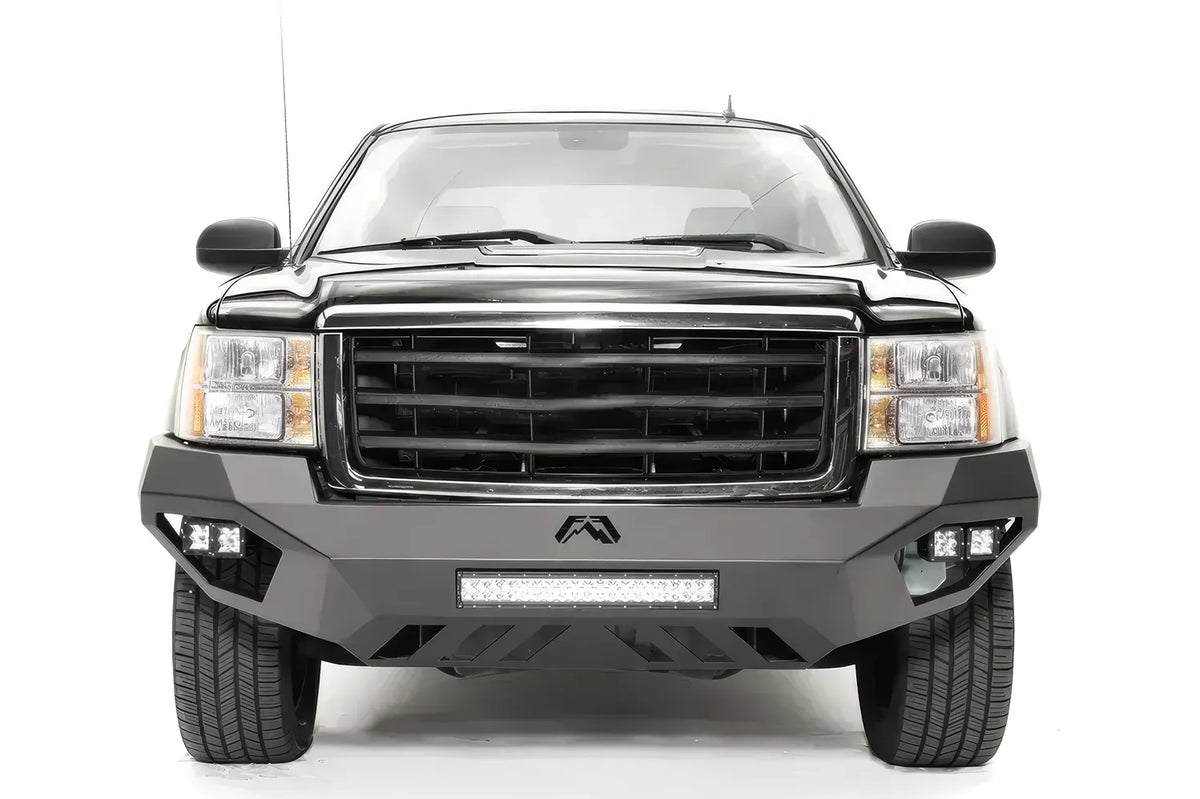 Fab Fours Vengeance front bumper on a black GMC Sierra 1500, straight-on front view, showing the full-width bumper face, center light bar and cube light pods