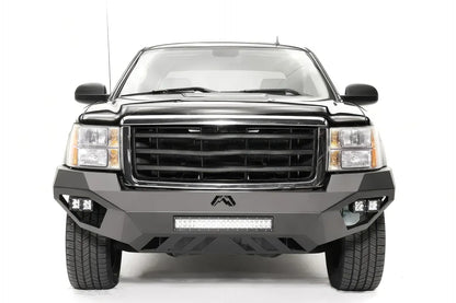 Fab Fours Vengeance front bumper on a black GMC Sierra 1500, straight-on front view, showing the full-width bumper face, center light bar and cube light pods
